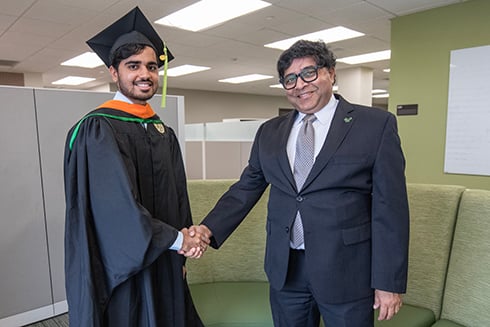 Bellini College Dean Sudeep Sarkar with one of the fall graduates.