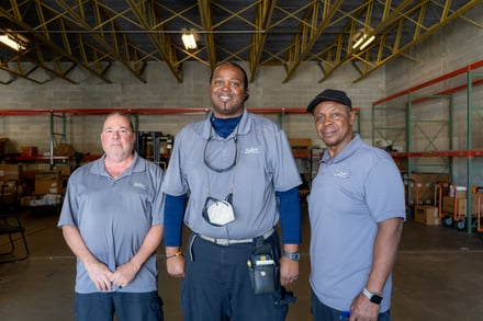 Central receiving team members pose for a photo.