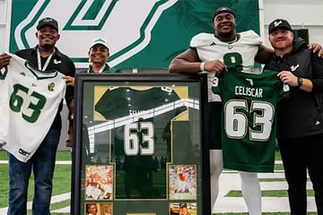 USF football coach Alex Golesh with defensive lineman Josh Celiscar